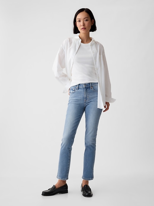 vintage slim jeans mit mittelhohem bund und schlitz-hem