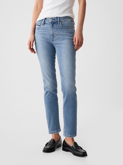 vintage slim jeans mit mittelhohem bund und schlitz-hem