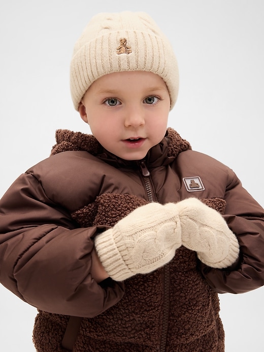 set aus baby- und kleinkind-mütze und fäustlingen aus weichem zopfmuster
